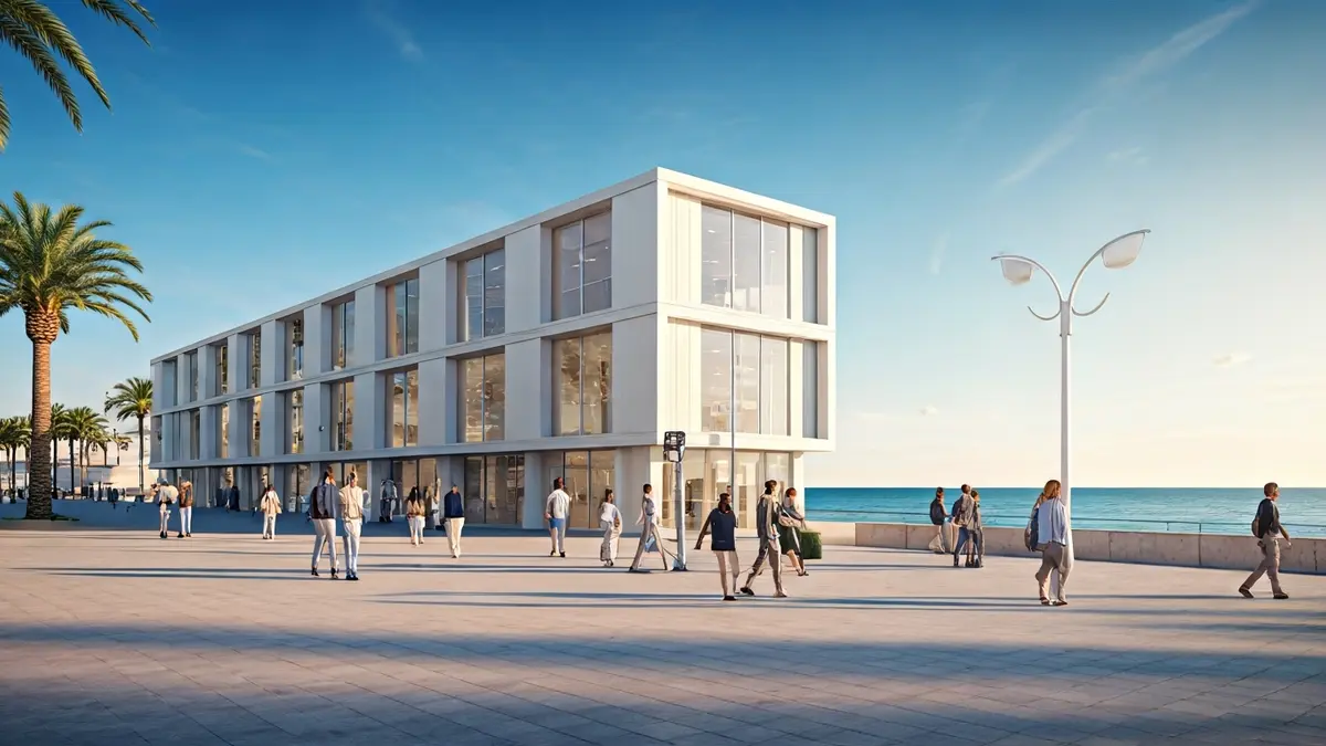 Imagen de un edificio modular moderno en un paseo marítimo, con palmeras y el mar de fondo.