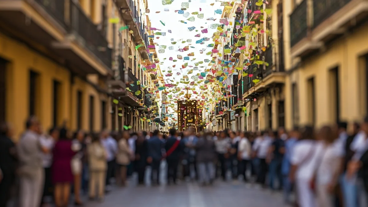 Image of colorful 'aleluyas' falling from balconies during a procession in Elx.