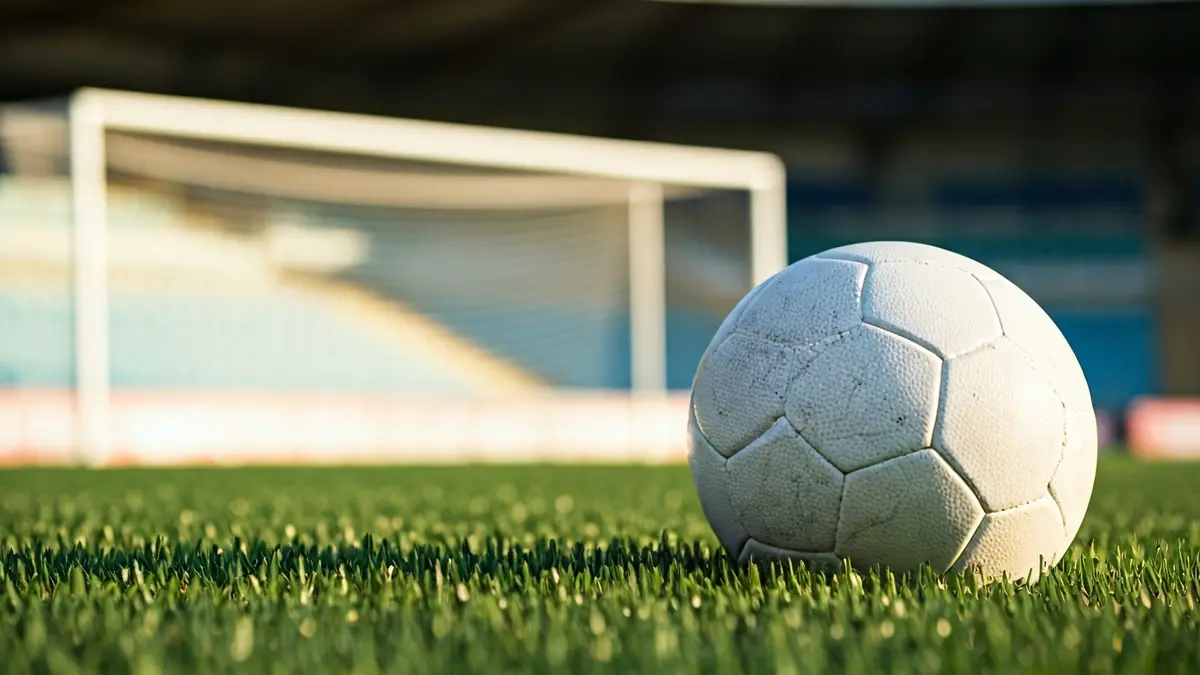 Generic image of a soccer ball on a stadium pitch.