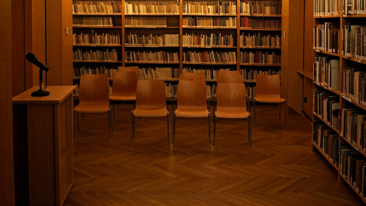 Generic image of a library with wooden bookshelves and a cozy reading atmosphere.