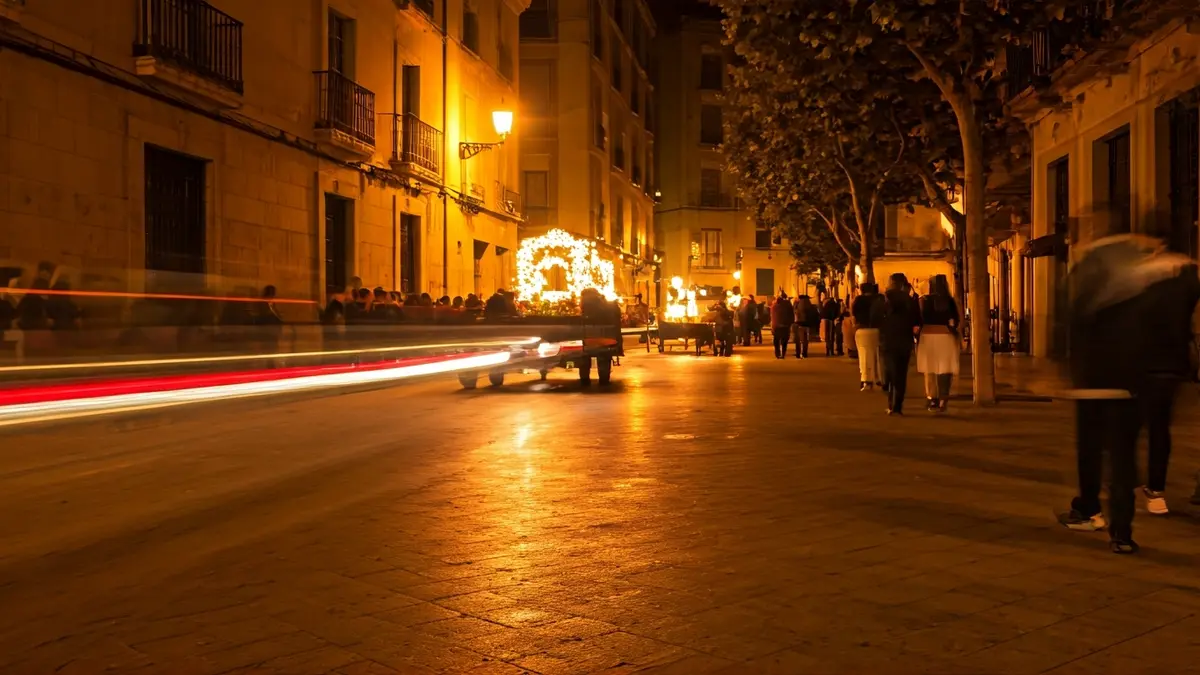 Image of a night parade with decorated carts and a bonfire at a traditional Valencian festival.