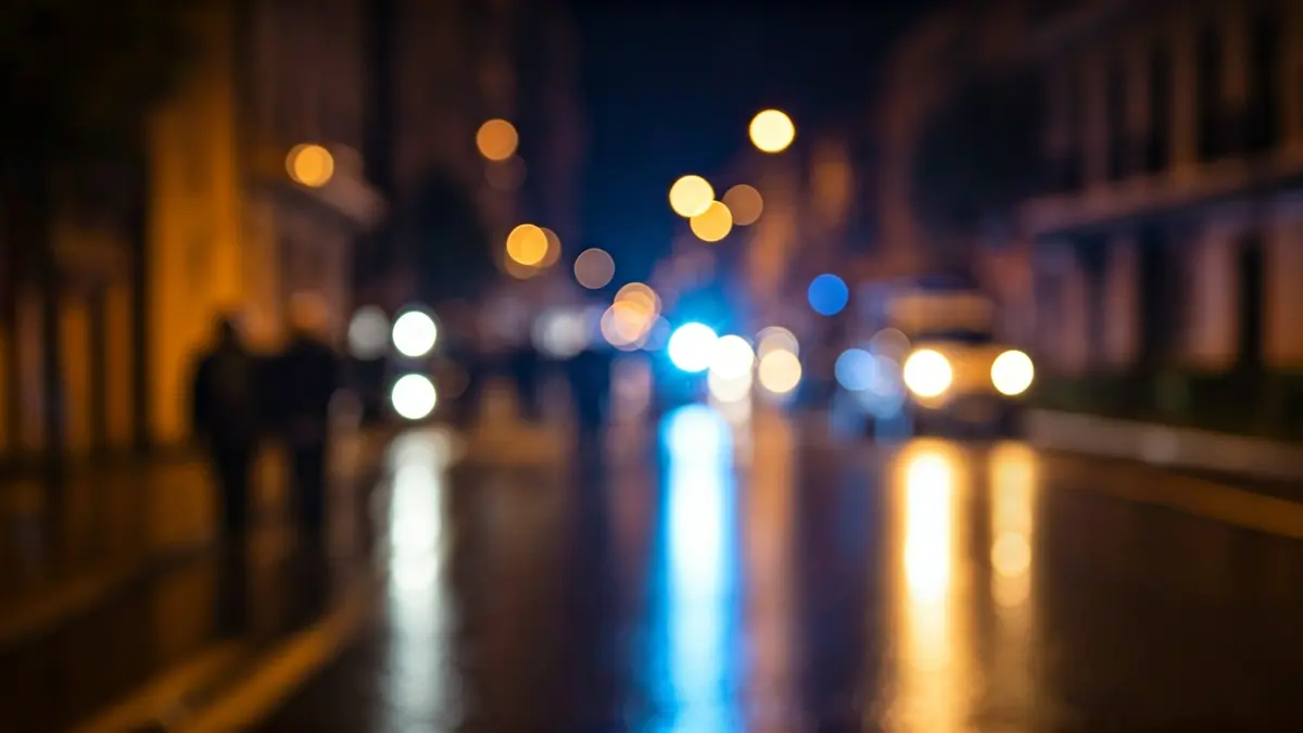 Generic image of emergency lights reflecting on wet asphalt at night.