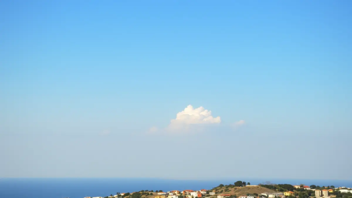 Generic image of a partly cloudy sky over a Mediterranean coastal town.