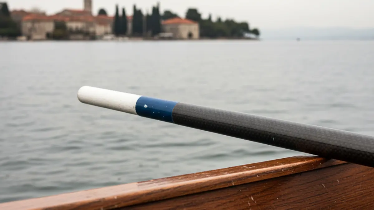 Generic image of an oar in a boat, with blurred water in the background.