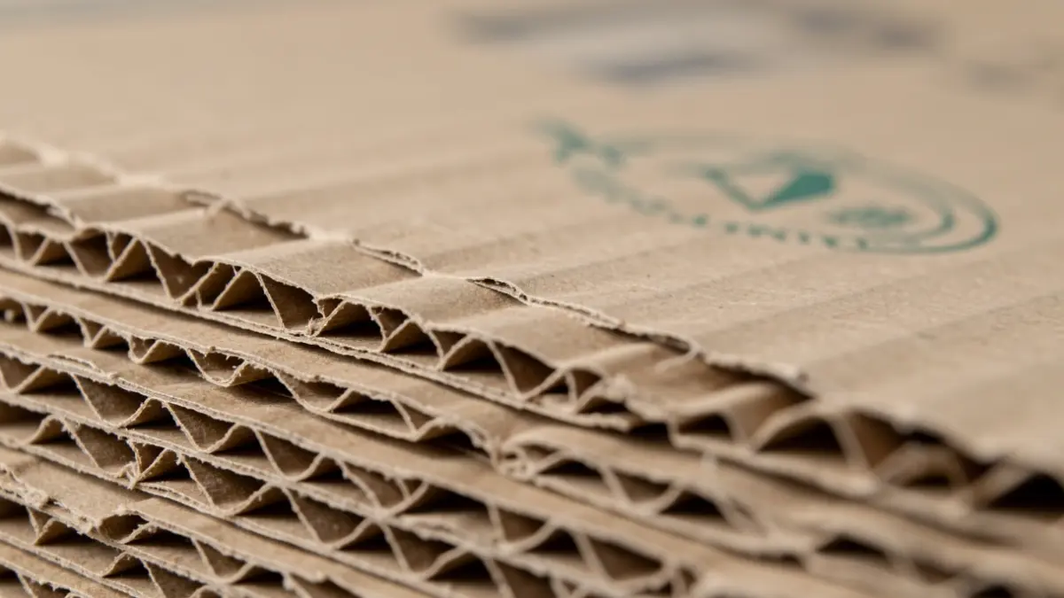 Generic image of corrugated cardboard packaging material with a blurred food safety seal.