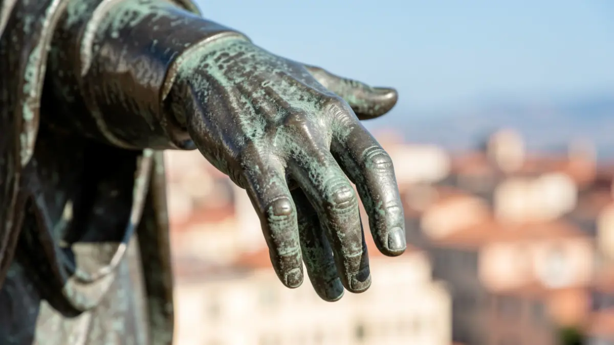Generic image of a bronze statue's hand.