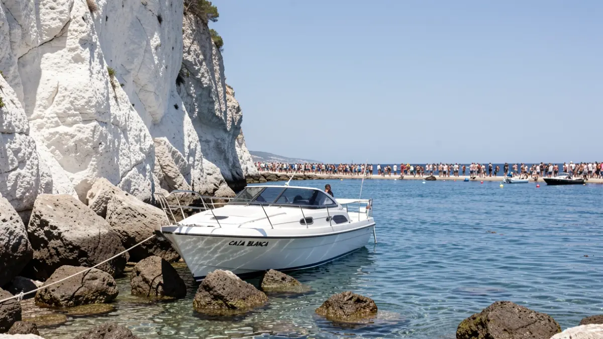 Image of a recreational boat grounded on rocks in Cala Blanca, Xàbia.