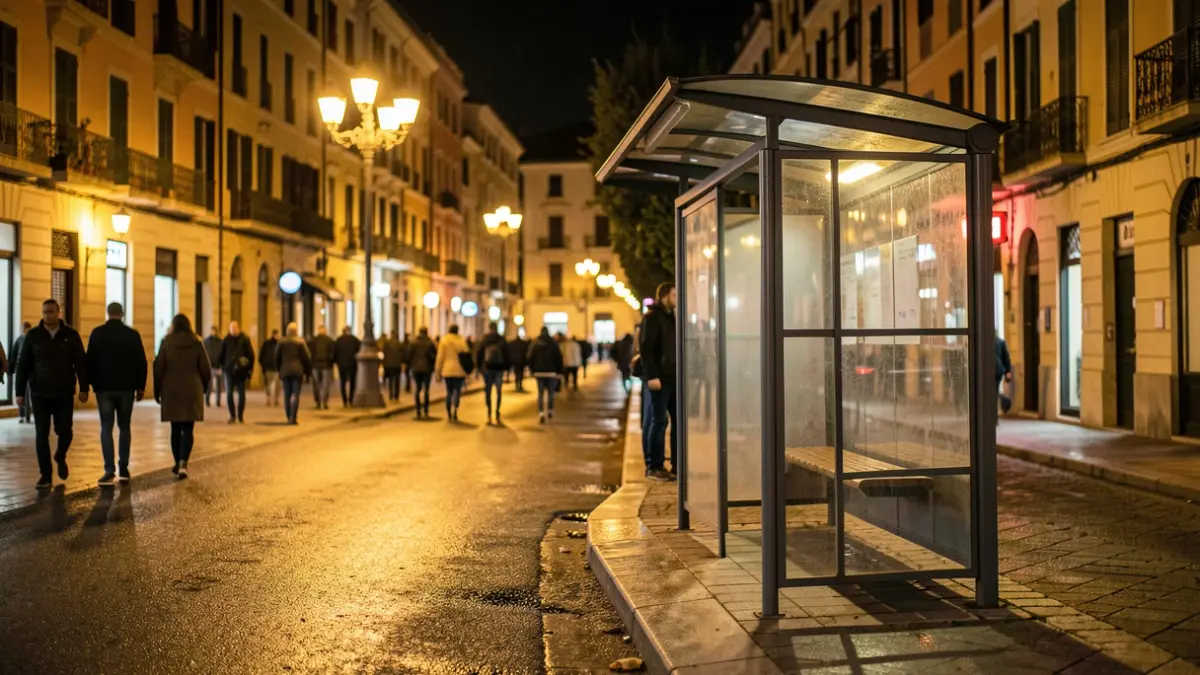 Generic image of an empty bus stop at night with streetlights.