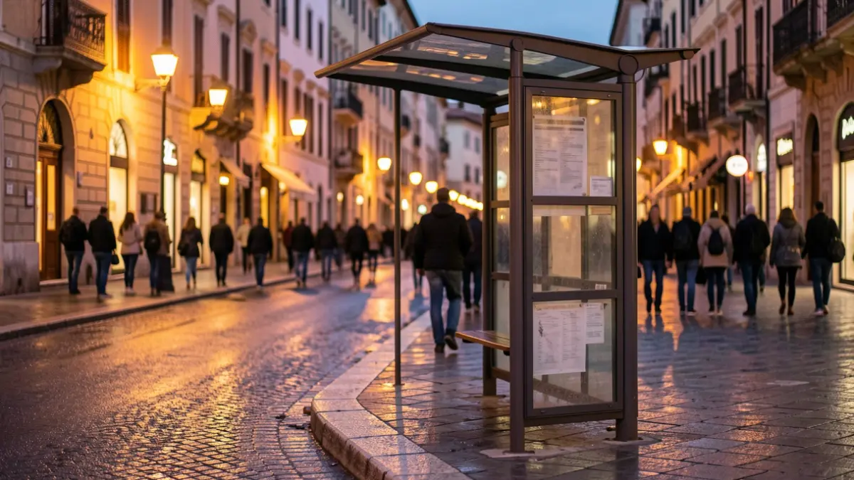 Generic image of a bus stop on a Mediterranean street at dusk.